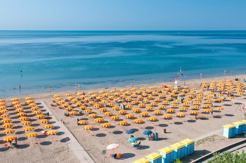 beach of Grado beach umbrellas sand and sea